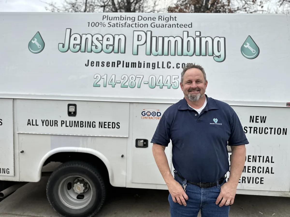 Todd Jensen standing beside a Jensen Plumbing vehicle