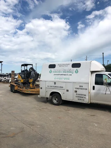 Jensen Plumbing vehicles at a job site