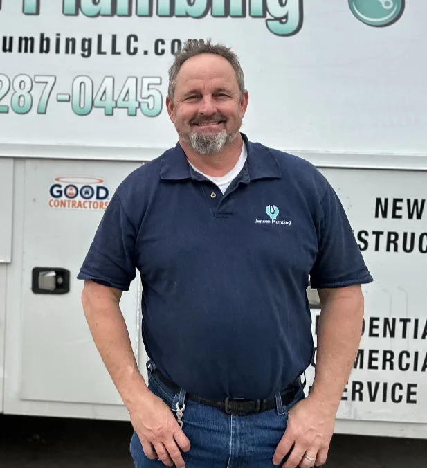 Todd Jensen beside a company vehicle